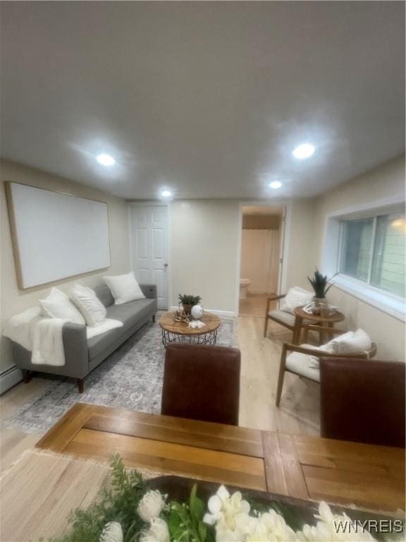 living room with wood finished floors and recessed lighting