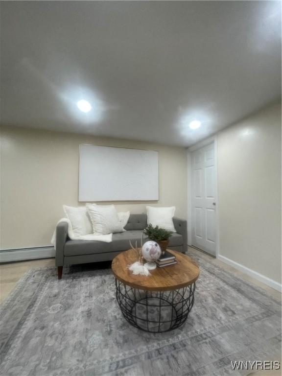 living area featuring recessed lighting, baseboards, and baseboard heating