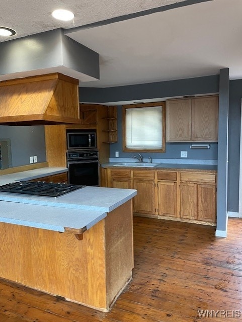 13289 Lakeview Dr, Carlton, NY 14571 - kitchen with gas cooktop, a sink, built in microwave, black oven, and dark wood-type flooring