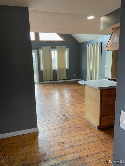 13289 Lakeview Dr, Carlton, NY 14571 - unfurnished living room featuring lofted ceiling, light wood-style floors, and baseboards