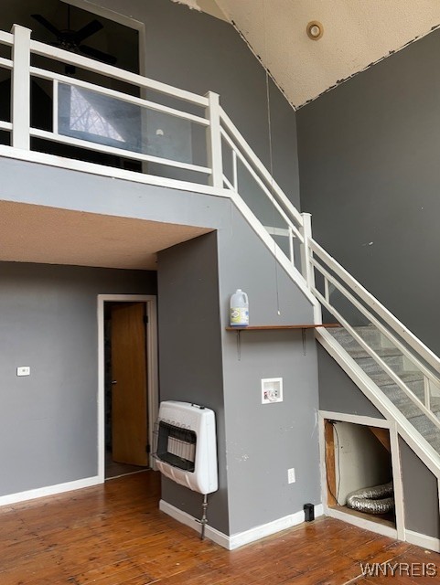 13289 Lakeview Dr, Carlton, NY 14571 - stairs with hardwood / wood-style floors, heating unit, baseboards, and a high ceiling