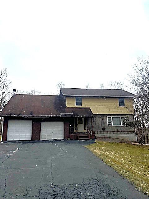 traditional-style home with aphalt driveway