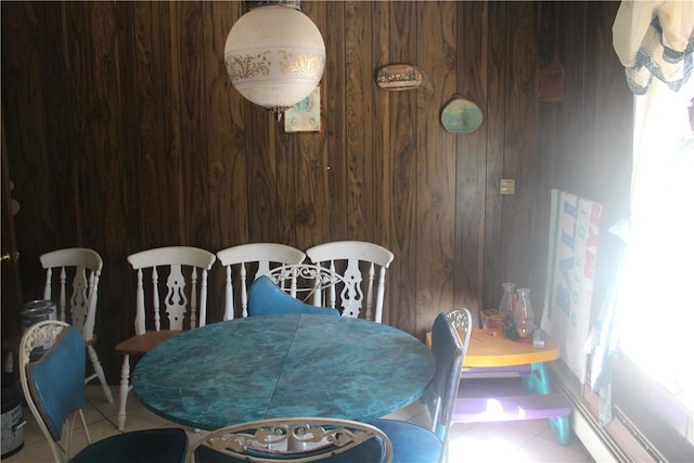 dining area featuring wood walls