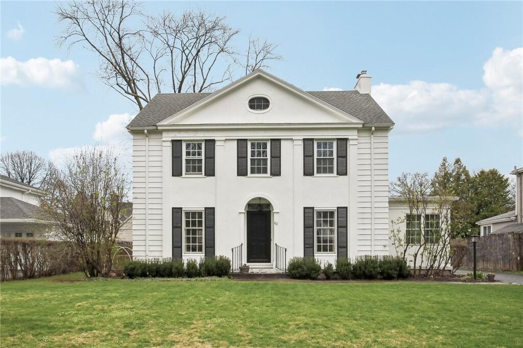 80 Edgemoor Rd, Brighton, NY 14618 - neoclassical / greek revival house with a front yard, entry steps, a chimney, and fence