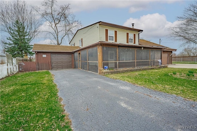 view of side of home featuring fence, a sunroom, and a garage