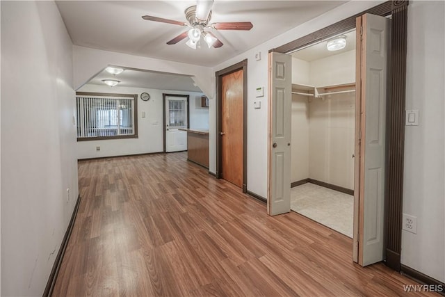 hall featuring baseboards and wood finished floors
