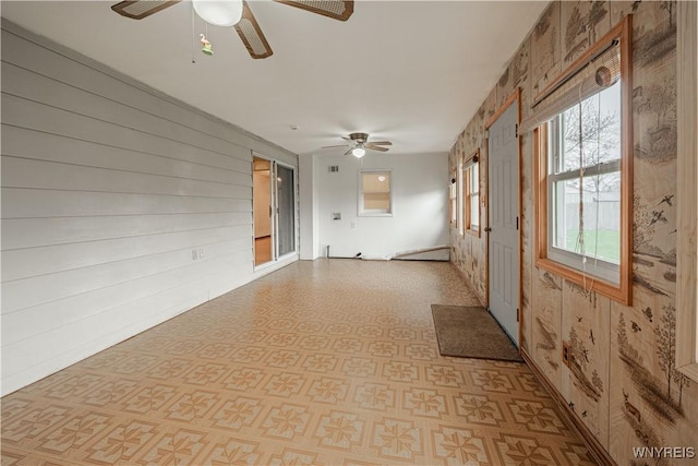 spare room featuring a ceiling fan and light floors