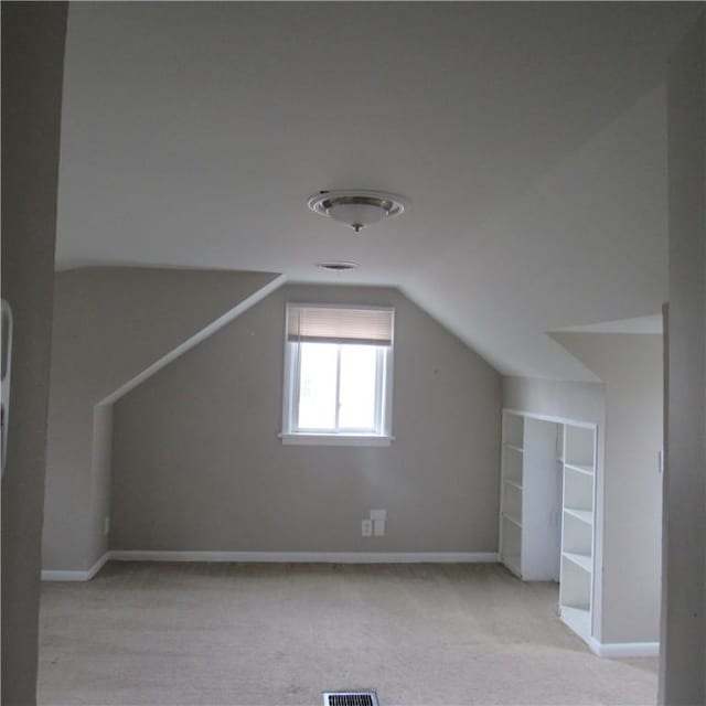 bonus room featuring vaulted ceiling, carpet floors, and baseboards
