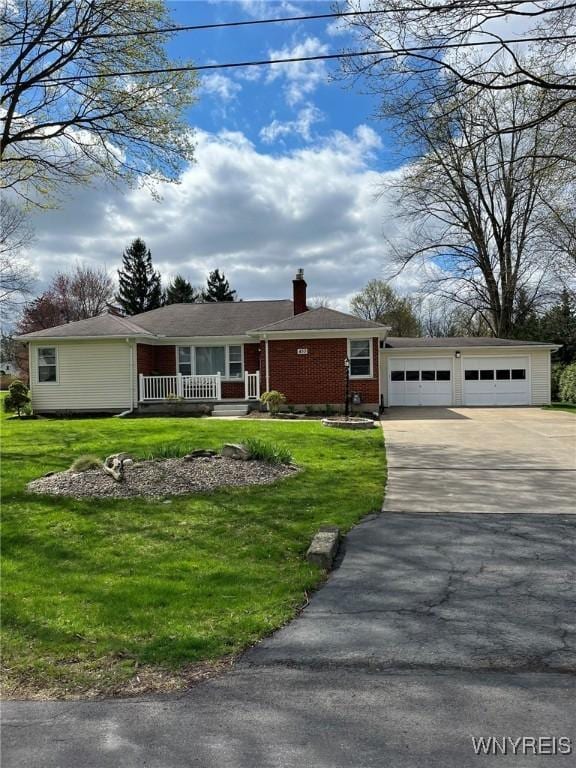 single story home with an attached garage, a front lawn, covered porch, and concrete driveway