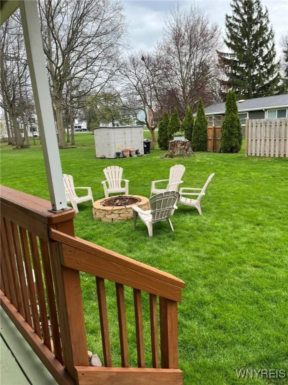 view of yard featuring fence and an outdoor fire pit