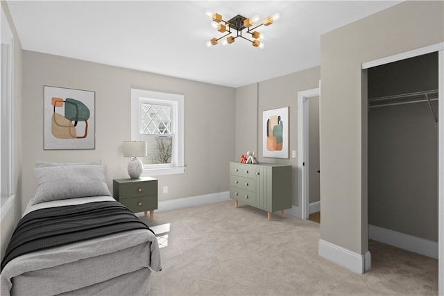 bedroom featuring baseboards, light colored carpet, and an inviting chandelier