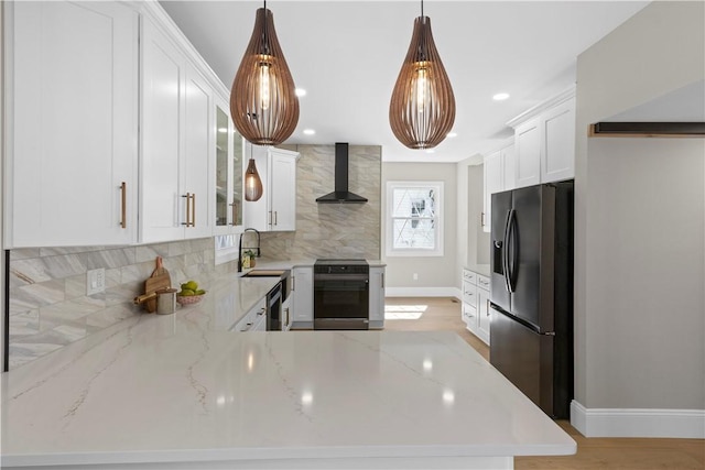 kitchen with dishwasher, fridge with ice dispenser, backsplash, wall chimney exhaust hood, and stove