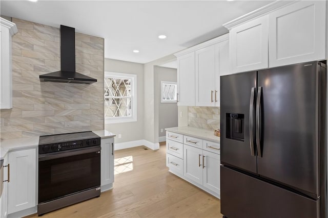 kitchen with wall chimney exhaust hood, tasteful backsplash, baseboards, black electric range, and refrigerator with ice dispenser