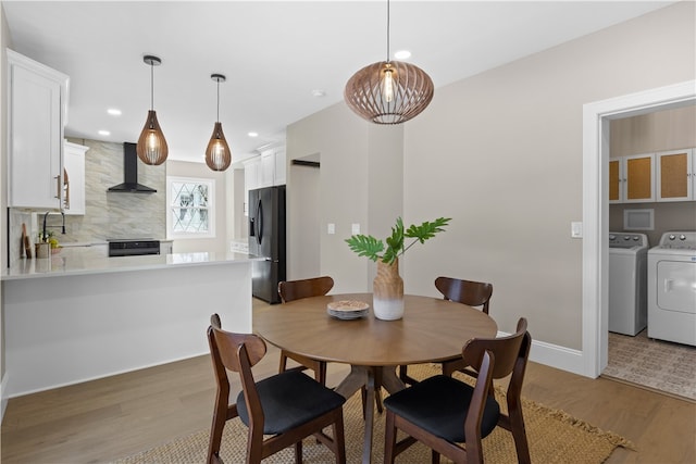 dining area with recessed lighting, baseboards, washing machine and clothes dryer, and light wood-style flooring