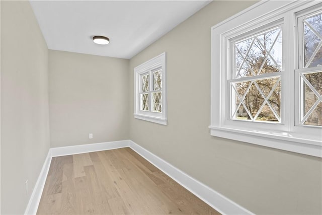 interior space featuring baseboards and wood finished floors