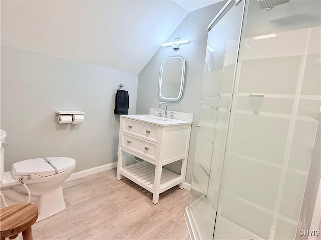 bathroom featuring a stall shower, toilet, baseboards, lofted ceiling, and wood finished floors