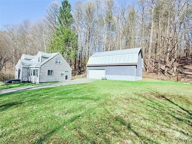 view of home's exterior featuring a lawn, an outdoor structure, and a garage