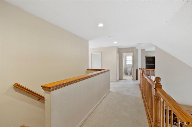 hall with light carpet, baseboards, recessed lighting, and an upstairs landing