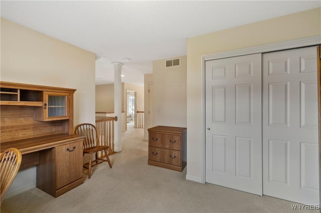 home office featuring visible vents, light colored carpet, and decorative columns