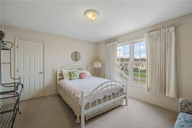 bedroom featuring baseboards and carpet flooring