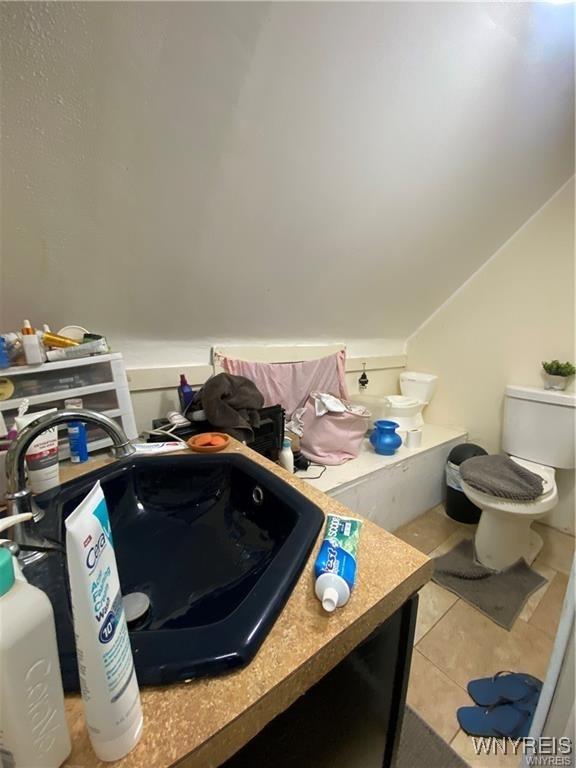 bathroom featuring tile patterned floors, a sink, and toilet