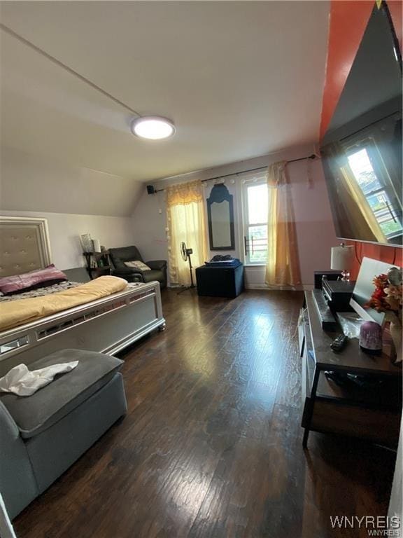 bedroom featuring lofted ceiling and wood finished floors