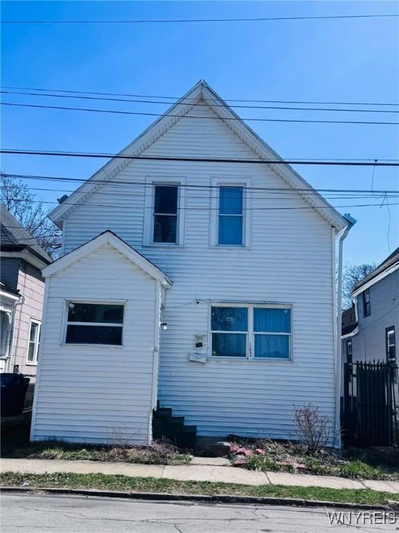 back of house featuring fence