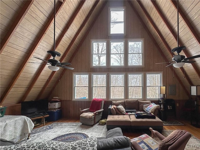 living area with wood finished floors, vaulted ceiling with beams, wooden ceiling, and ceiling fan