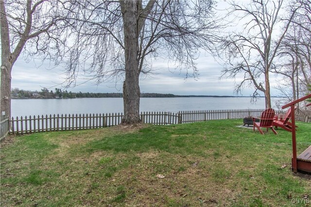 view of yard featuring a water view and fence