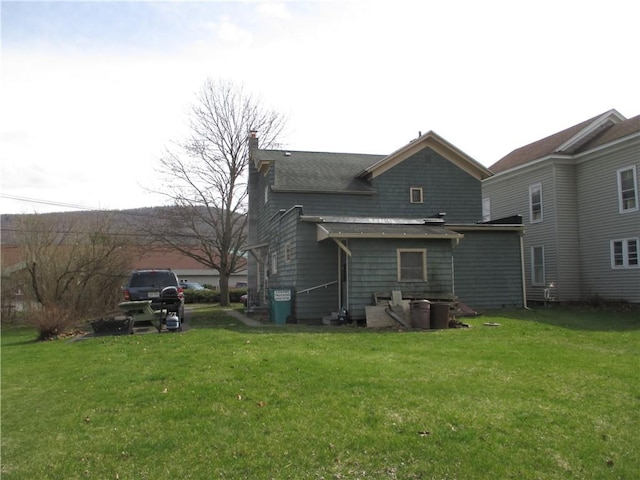 rear view of property with a lawn
