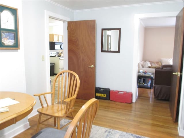 living area featuring ornamental molding and light wood-type flooring