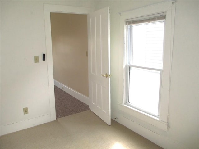 unfurnished room with plenty of natural light and carpet floors