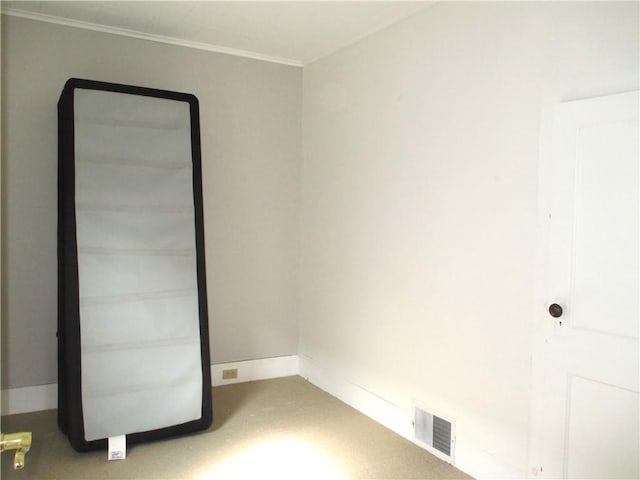 carpeted empty room with visible vents and ornamental molding