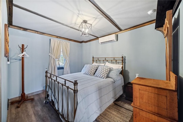 bedroom with wood finished floors and a wall unit AC