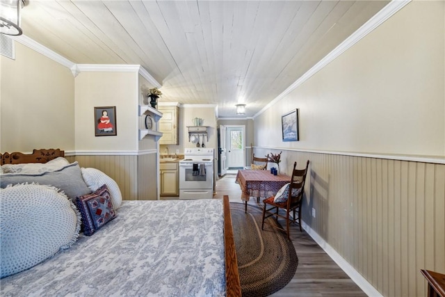 bedroom featuring crown molding, wood finished floors, a sink, wainscoting, and wood ceiling