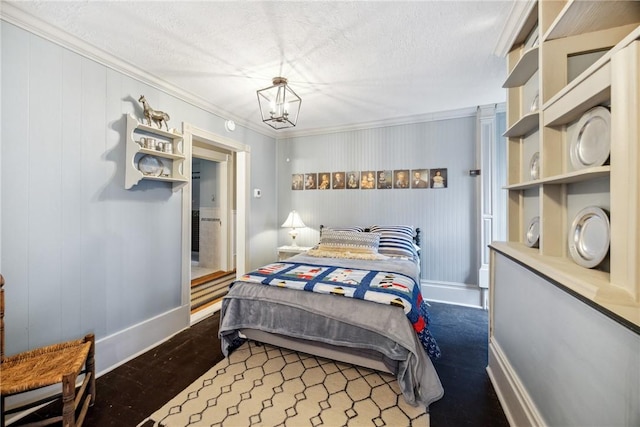 bedroom with baseboards, a textured ceiling, a notable chandelier, and ornamental molding