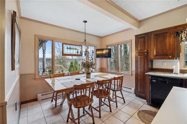 dining room with a notable chandelier, crown molding, a healthy amount of sunlight, and light tile patterned floors