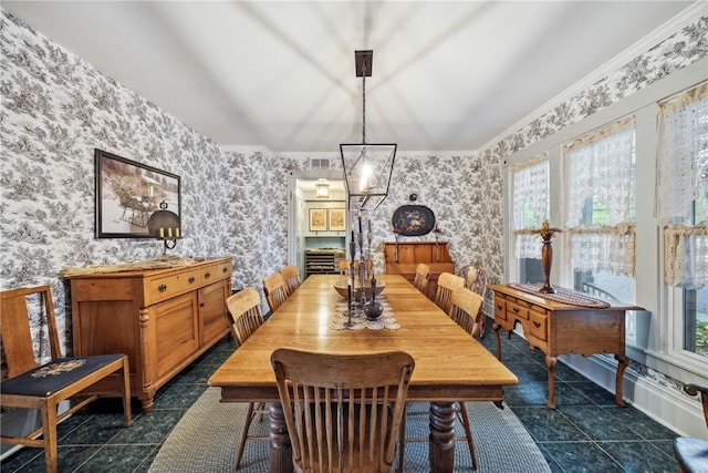 dining space with ornamental molding and wallpapered walls