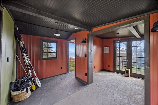 interior space featuring baseboards, french doors, and beam ceiling