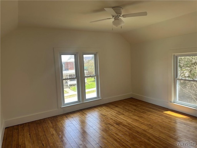 bonus room featuring hardwood / wood-style flooring, vaulted ceiling, a ceiling fan, and baseboards
