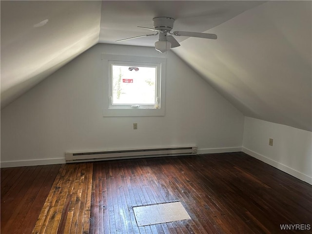 additional living space with hardwood / wood-style floors, vaulted ceiling, a baseboard heating unit, baseboards, and ceiling fan