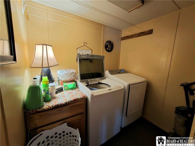 clothes washing area with washing machine and clothes dryer and laundry area