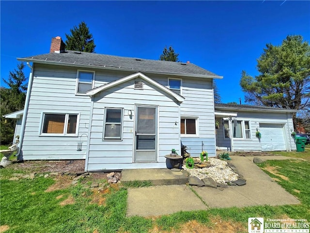 rear view of property with a lawn and a chimney