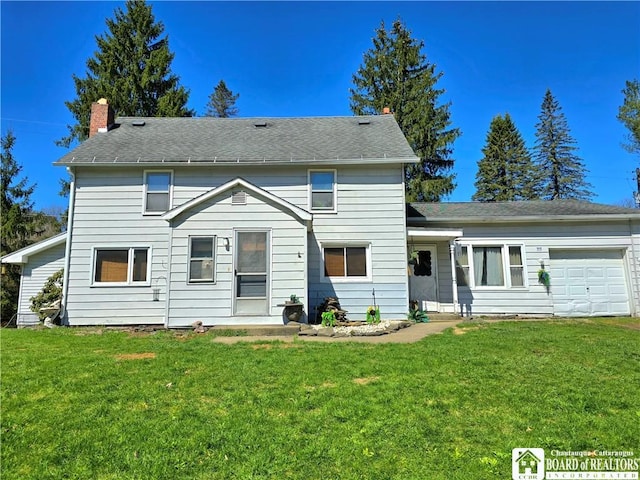 view of front of home with an attached garage and a front yard