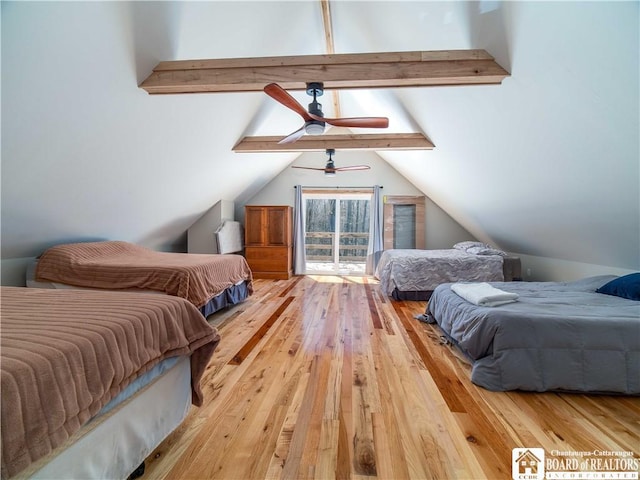 bedroom featuring wood-type flooring and vaulted ceiling with beams