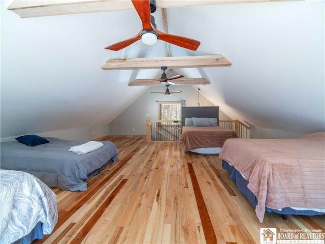 bedroom featuring wood-type flooring and lofted ceiling with beams