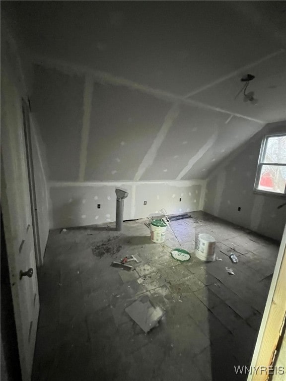 additional living space featuring vaulted ceiling