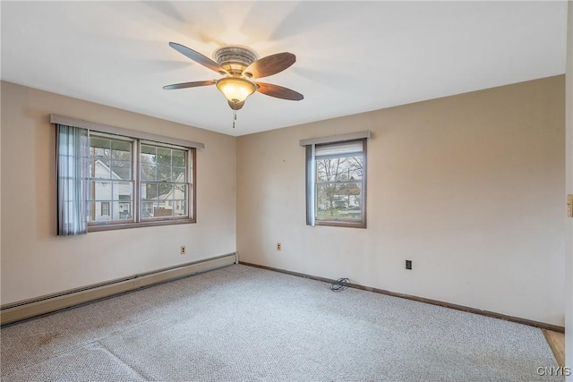 empty room featuring carpet floors, ceiling fan, a baseboard heating unit, and baseboards