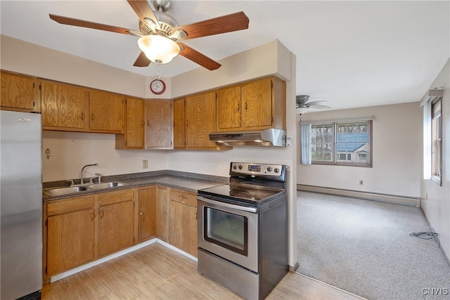 kitchen with a sink, a baseboard radiator, under cabinet range hood, a ceiling fan, and appliances with stainless steel finishes