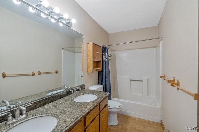 full bath with toilet, a sink, shower / tub combo with curtain, and wood finished floors